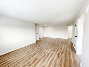 Overland Park apartment for rent - an empty living room with wood floors and white walls