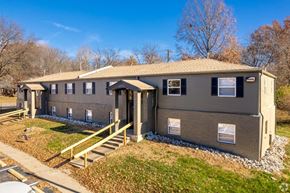 Grandview apartment for rent - A small building with a brown roof and a porch.