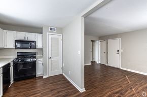 Grandview apartment for rent - A kitchen with white cabinets and a black stove top oven.