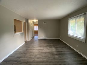 Spring Hill apartment for rent - large living room with vinyl plank flooring and breakfast bar