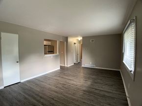 Spring Hill apartment for rent - large living room with vinyl plank flooring and breakfast bar