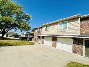 Blue Springs apartment for rent - A residential building with a tree in front of it.