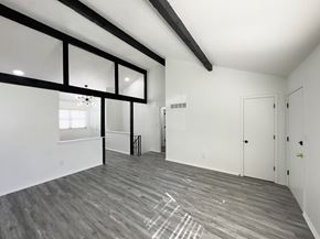 Blue Springs apartment for rent - the living room of a new home with white walls and wood flooring