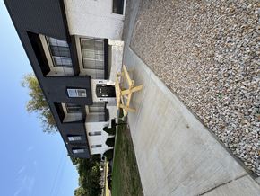 Kansas City apartment for rent - A modern house with a stone wall in front.