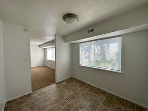 Kansas City townhouse for rent - a bedroom with a large window and a tiled floor