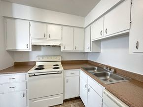 Kansas City townhouse for rent - a kitchen with white cabinets and white appliances