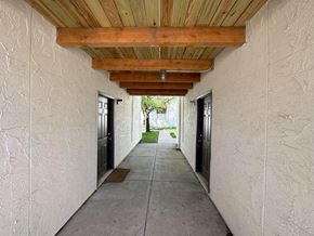 Kansas City townhouse for rent - a hallway with doors and a wooden ceiling