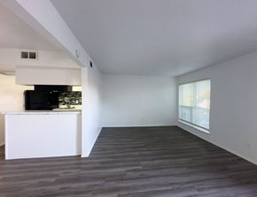 Dallas apartment for rent - A spacious room with a white cabinet and a television.