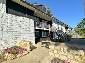 Riverside apartment for rent - the front of a building with a staircase and a stone wall