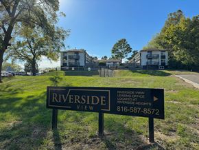 Riverside apartment for rent - a view of riverside view apartments from the street with a sign