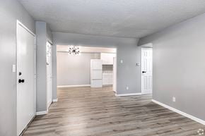 Maryville apartment for rent - an empty living room and kitchen with white walls and wood flooring