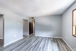 Maryville apartment for rent - an empty living room with wood flooring and white walls