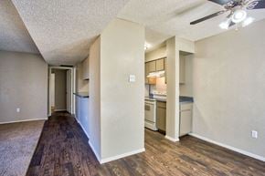 Arlington apartment for rent - the living room and kitchen of an apartment with a hard wood floor