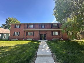 Spring Hill apartment for rent - A red brick building with a black door and windows.