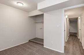 Kansas City apartment for rent - a bedroom with a medium sized walk in closet and a carpeted floor