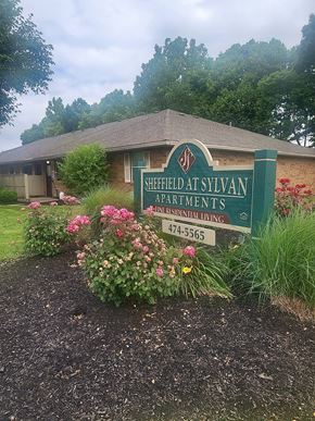 Circleville apartment for rent - Property sign with flowers at Sheffield at Sylvan in Ohio