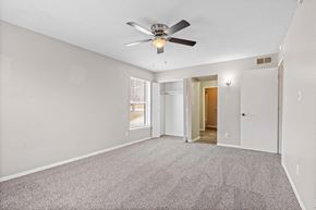 Kansas City apartment for rent - A room with a ceiling fan and carpeted floor.