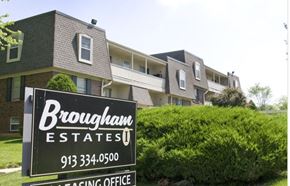 Kansas City apartment for rent - A sign for Brougham Estates in front of apartment buildings.