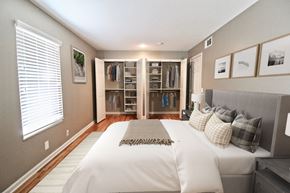 Kansas City apartment for rent - A bedroom with a large bed and a walk-in closet.