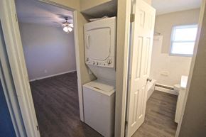 Kansas City apartment for rent - A white toilet is in a small room with a door open to a bathroom.