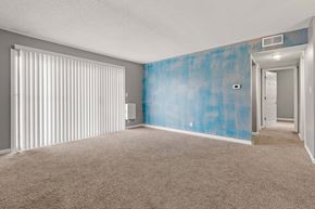 Kansas City apartment for rent - A room with a blue wall and carpet.