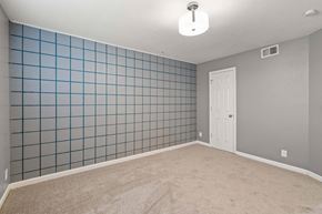Kansas City apartment for rent - A room with a white door and a blue tile wall.