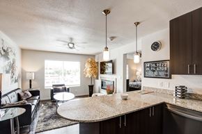 Overland Park apartment for rent - A modern kitchen and living room with a large island in the center.