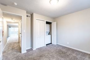 Gladstone apartment for rent - A bedroom with a white door and a window.