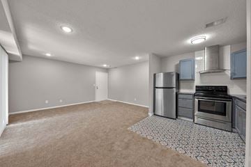 Blue Springs apartment for rent - A kitchen with a refrigerator, oven, and stove.