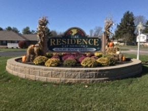 Newark apartment for rent - a sign for the residence is in the middle of a yard