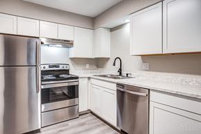 Kansas City apartment for rent - a kitchen with white cabinets and stainless steel appliances