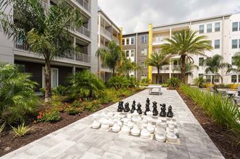 A large chess board in the middle of an apartment complex