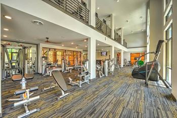 A room filled with lots of different types of exercise equipment