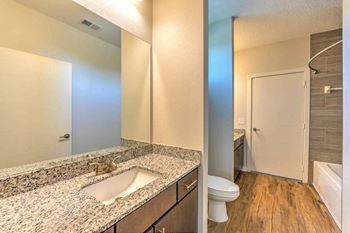 A bathroom with a sink toilet and shower