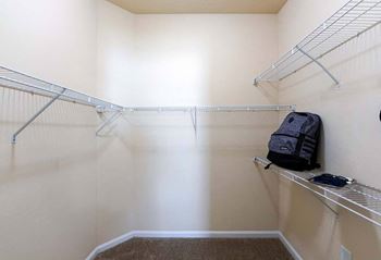 A walk in closet in a bedroom plus den unit