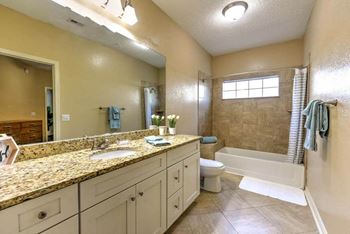 Spacious bathrooms with granite counters, tile floors and lots of vanity space