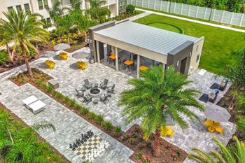 A backyard with a pavilion and palm trees