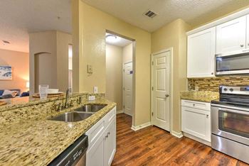 Kitchen with granite counters, pantry and stainless steel appliances