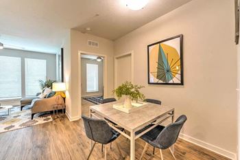 A dining room with a table and chairs