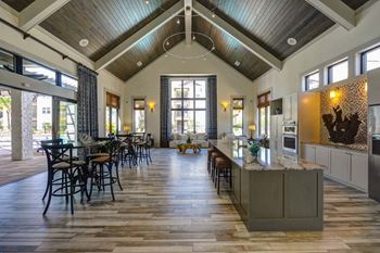 A kitchen with a long counter and a window
