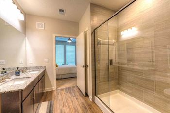A bathroom with a shower and a sink