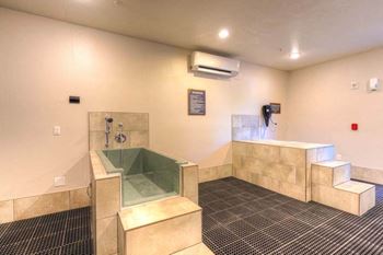 A large bathroom with a tub and a shower