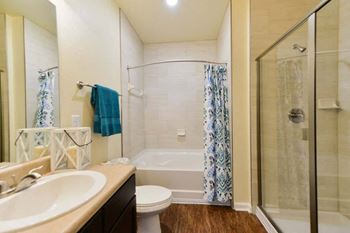 A bathroom with a sink toilet and shower
