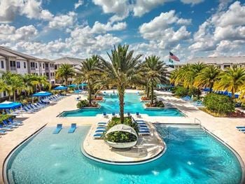 A large swimming pool with a fountain in the middle of it