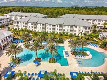 An aerial view of a resort with a large swimming pool