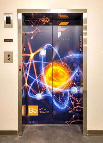 A elevator with a painting on the side of it