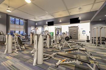 A room filled with lots of different types of exercise equipment