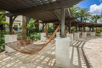 A hammock is sitting in the middle of a patio