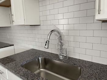 A kitchen with a sink and a faucet