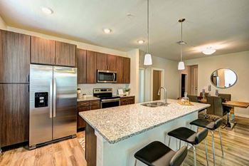 A kitchen with a counter top and a refrigerator
